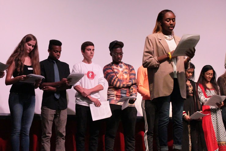 Here I am sharing my own definitions of feminism during our feminism class's annual International Day of the Girl assembly (photo credit: Lexie Clinton). 