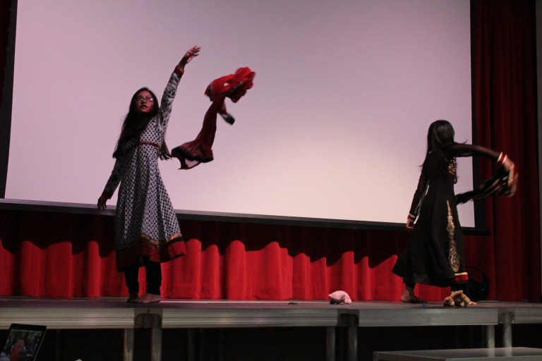 Me (left) and Mirwat (right) doing our dance on domestic violence during the IDG assembly. (photo cedit: Lexie Clinton)